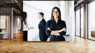 business woman leading a corporate team in front of talking colleagues Wall mural